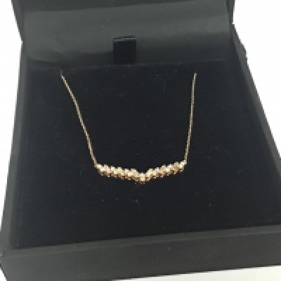 A 14carat gold (585) necklace set with a row of small baguette stones in a fitted box weight 1.5g
