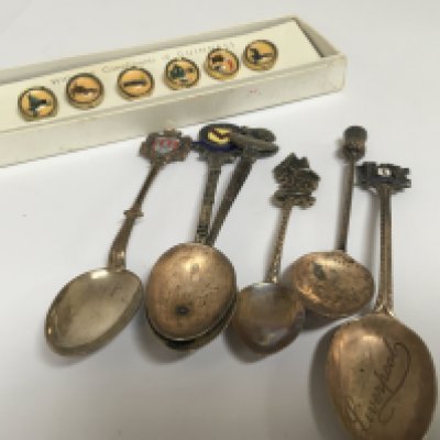 A set of Vintage Guinness dress buttons and a quantity of white metal and silver tea spoons.