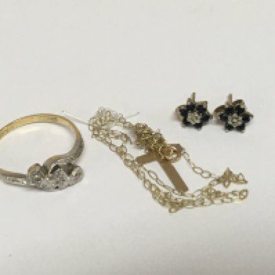 An 18carat gold ring set with chip stone diamonds a pair of sapphire and diamond earrings and a gold cross and chain.