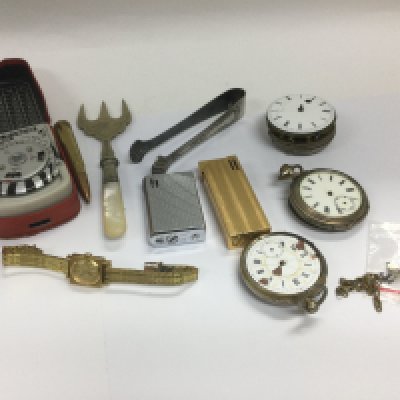 A box of oddments comprising pocket watch parts, lighters etc. Shipping category D.