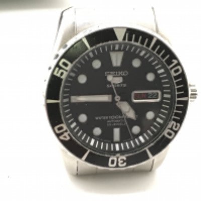 A boxed Seiko sports watch with papers and tag. Not seen running. Black dial. Approximately 45mm including crown.