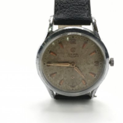 A gents vintage CYMA Triplex watch. Winds and runs. Postage B