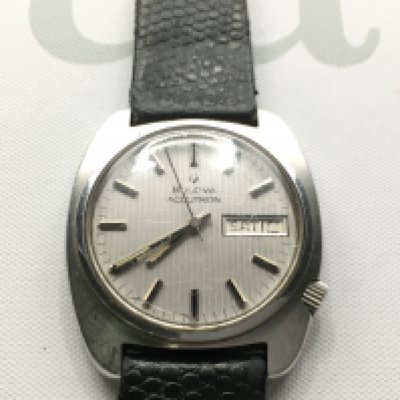 A gents Bulova Accutron day date wrist With silver coloured dial and black leather strap. Seen running.