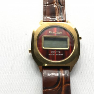 Bulova quartz solid state wrist watch with brown leather strap. Not seen working. Postage B