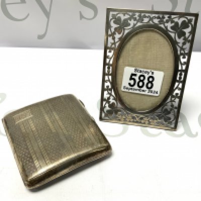 A small pierced hallmarked silver photo frame with a 3 leaf clover design marks for Chester 1901, by John Millward Banks. Together with a hallmarked silver cigarette case. (B)