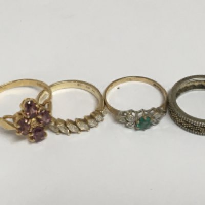 A 14carat gold QVC ring set with CZ Two 9carat gold rings set with amethyst and green coloured stones and an eternity ring. total weight 7.5g