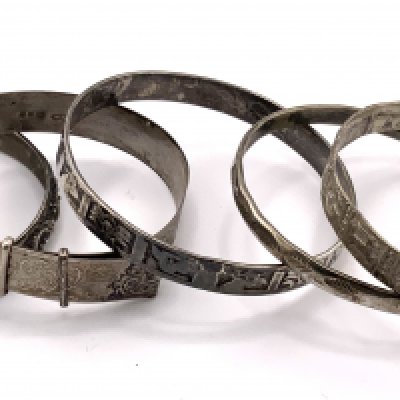 5 silver and white metal bangles. (A)