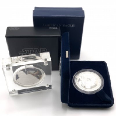 A cased star wars captain Phasm fine silver coin together with a 2006 USA fine silver American eagle, West Point mint. (A)