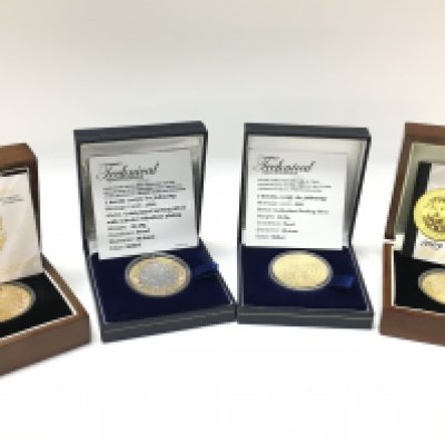 Four cased commemorative gold plated sterling silver coins. Postage category B