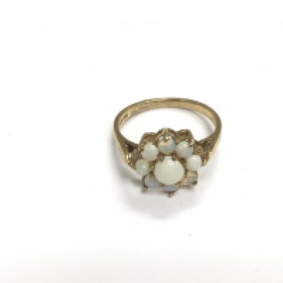 A 9ct gold ring set with opals in the form of a flower head, approx 2.8g and approx size O-P. Shipping category A.