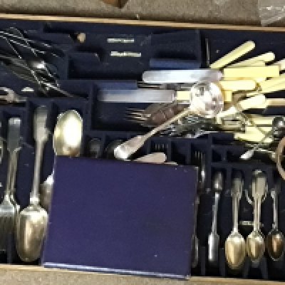 An oak and metal bound strong box with a fitted interior containing silver plated cutlery a pair of chamber sticks with a George III silver candle snuffer and a Victorian tea set.