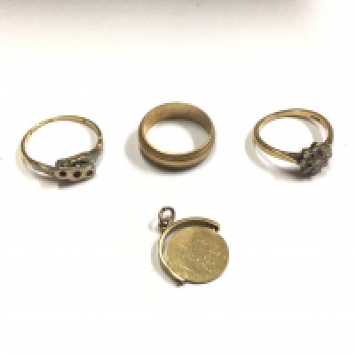 Three 9ct gold rings and one 9ct gold charm. Approx weight 7.47 grams.
