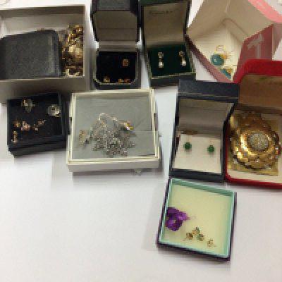 A large collection of earrings and studs including plated examples as well as 9ct gold and silver examples.