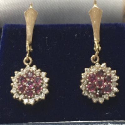 A 9ct gold pair of diamond and ruby earrings. 2.6g total weight. Postage category a