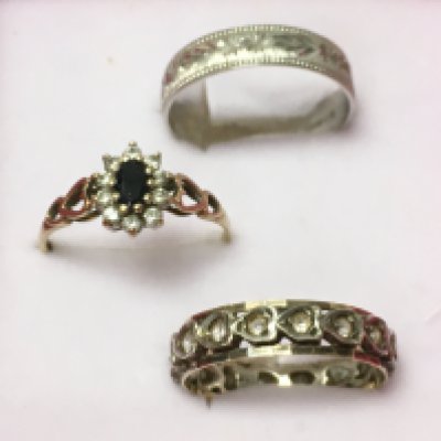 A 9ct carat white gold band, a 9ct gold and silver eternity ring and a 9ct gold sapphire and cubic zirconia set ring. Total weight 5.3g. Size N/O, M, R. Postage category a