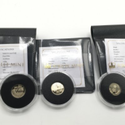 Three 1g 9ct gold coins of various design.