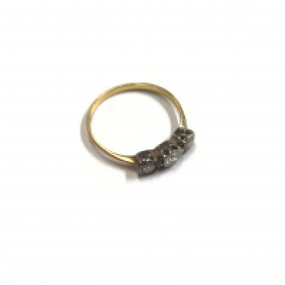 An 18ct gold three stone diamond ring. Approx size R.