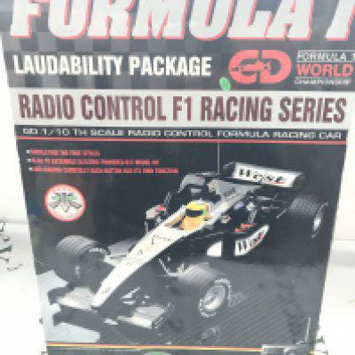 A Boxed Gaoodeng F1 R/C Racing Car. A Scalextric Jaguar Challenge Set And A Christmas Holiday Train Set.(3)