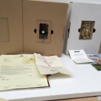Two boxed Steiff minature teddy bears produced as annual gifts to Steiff Club members. Featuring a 7cms black mohair bear for 2000 and a 10cms blond tipped bear for 2016. Both with certificates and other paperwork. No reserve. (2)