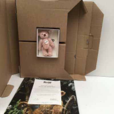 A boxed minature Steiff teddy bear featuring a pale pink 10cms bear from 2013. Certificate included. No reserve