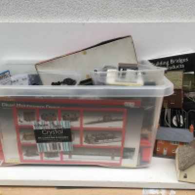 A large box containing an assortment of 00 and HO gauge model railway accessories including buildings..track..power supply etc. manufacturers include Hornby..Peco and others. No reserve