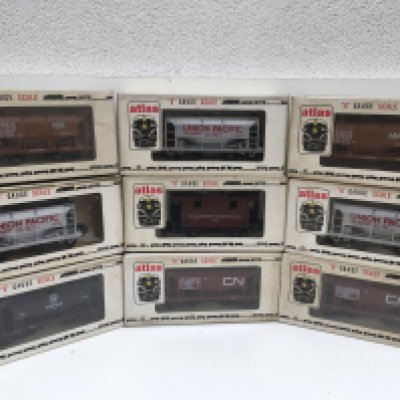 A collection of 9 boxed O gauge rolling stock wagons by atlas. No reserve