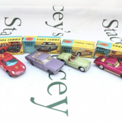 4 Boxed Corgi Vehicles. A Ferrari Berlinetta #314. A Ford Mustang #320. A Triumph TR.3 Sports Car #305 And A Chevrolet Corvette Sting Ray #310. Boxes Are Worn.