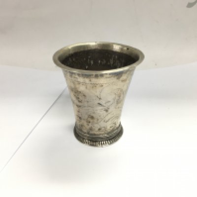 An old patterned jug with worn detail and hallmarks.