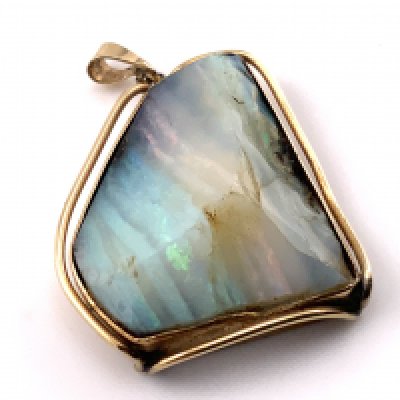 WITHDRAWN - A 9ct gold mounted opal (cross section). 25mm x 21mm. (A) 7.98g.