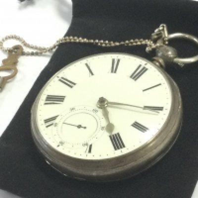 A 20th century silver hallmarked cased pocket watch with a subsidiary dial and key. Postage category A