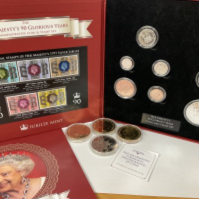 90 glorious years of Queen Elizabeth commemorative coin and stamp set along with four other commemorative coins. Postage category A.