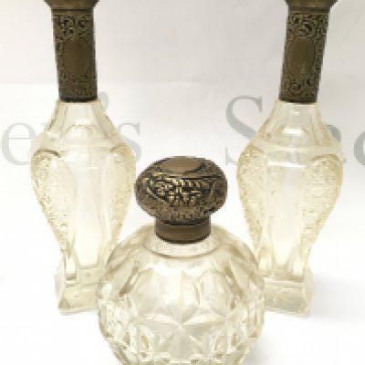 Three silver topped cut glass dressing table items , perfume bottle and a pair of vases. 13 & 21cm tall. This lot cannot be posted