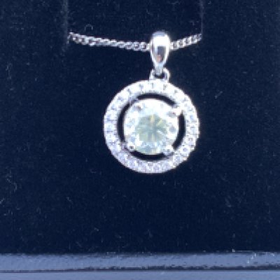 Platinum pendant set with central RBC diamond and a halo of smaller RBC diamonds on a silver chain, boxed. Centre diamond 1.01ct. Remaining diamonds 0.15ct. Postage category A.