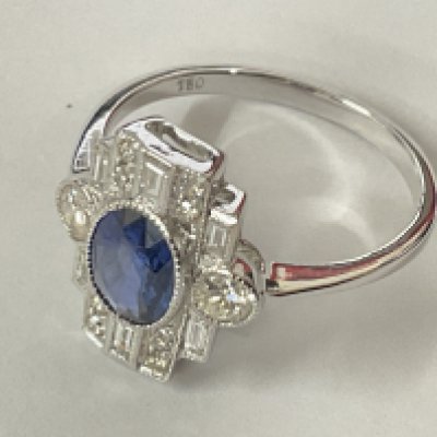 Certificated 18ct white gold art deco style oval sapphire and RBC and baguette cut diamond ring. Sapphire 1.02ct. Diamonds 0.55ct. Cert no. WGI9634157946. Postage category A.