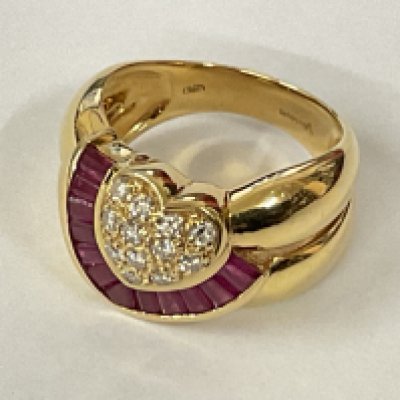 18ct yellow gold heavyweight ring featuring a heart shape set with RBC diamonds and half halo channel set with calibre/mixed cut rubies. Rubies 0.80ct approx. Diamonds 0.25ct approx. Postage category A.