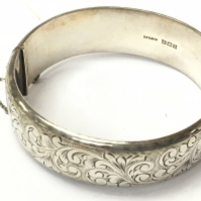 A Silver hallmarked bangle with engraved design. Postage category A