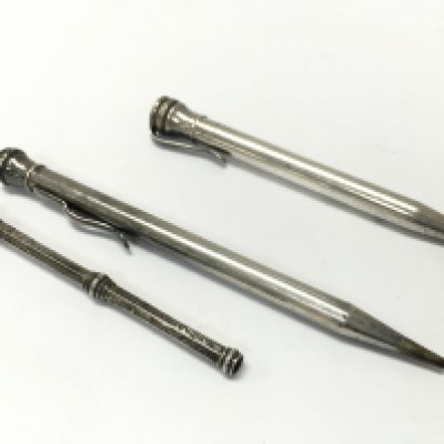 Three silver pencils , postage cat A