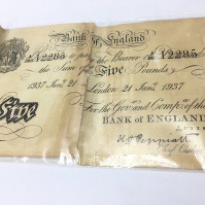 A 1937 white &pound;5 note, split in half. Postage category A