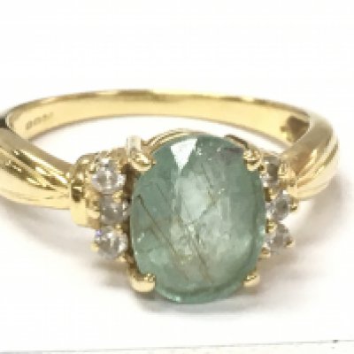 An 18ct gold diamond and green stone ring , size N . 3.9g Postage category A
