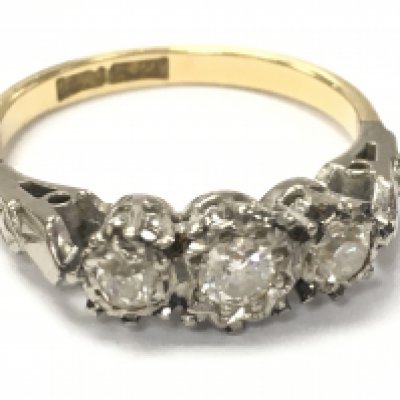 An 18ct gold three stone diamond ring , 2.9g total weight. Postage category A