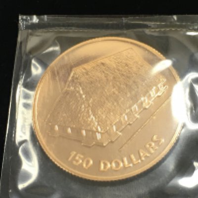 A 1979 Kiribati 150 dollars gold coin. 15.98g 22ct