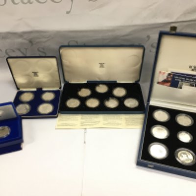 A collection of silver cased coins including silver liberty coins. Postage B