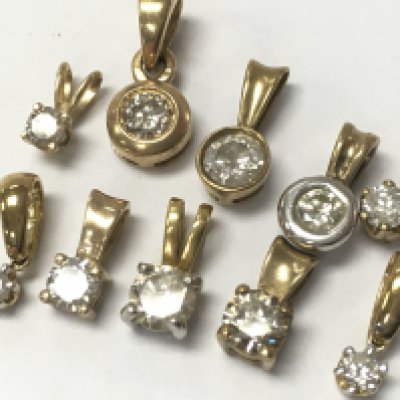 9ct gold diamond solitaire pendants, 4.3g total weight . Postage category A