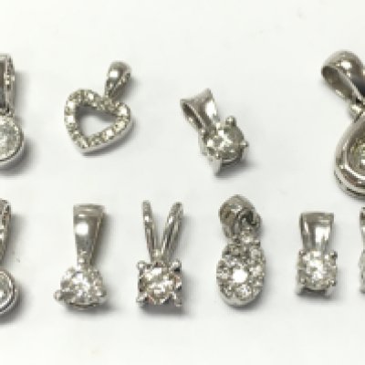 A collection of 9 ct white gold diamond solitaire pendants , 4.9g total weight. Postage category A