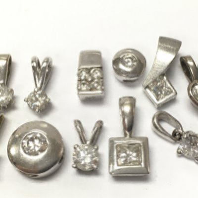 A collection of 18ct white gold solitaire pendants , 8.1g total weight. Postage category A