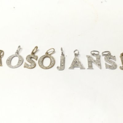 A collection of 9ct yellow and white gold diamond initial pendants . 6.4g. Postage category A