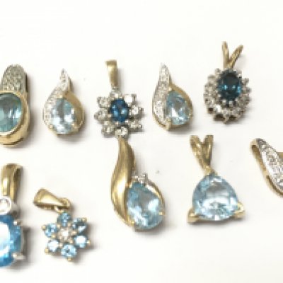 A collection of 9ct mixed blue topaz and diamond pendants , 7.4g total weight. Postage category A