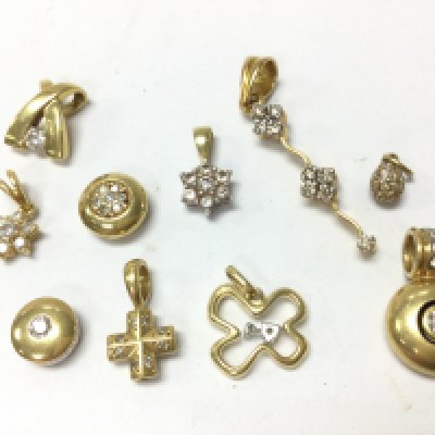 A collection of 18ct gold diamond inset pendants , 15.1g total weight . Postage category A