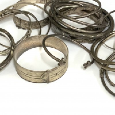 A large collection of silver and white metal bangles, approx 350g total weight. (A)