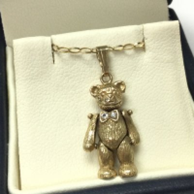 A 9 carat gold Teddy pendant on a 9ct chain, 3.5g . Postage category A